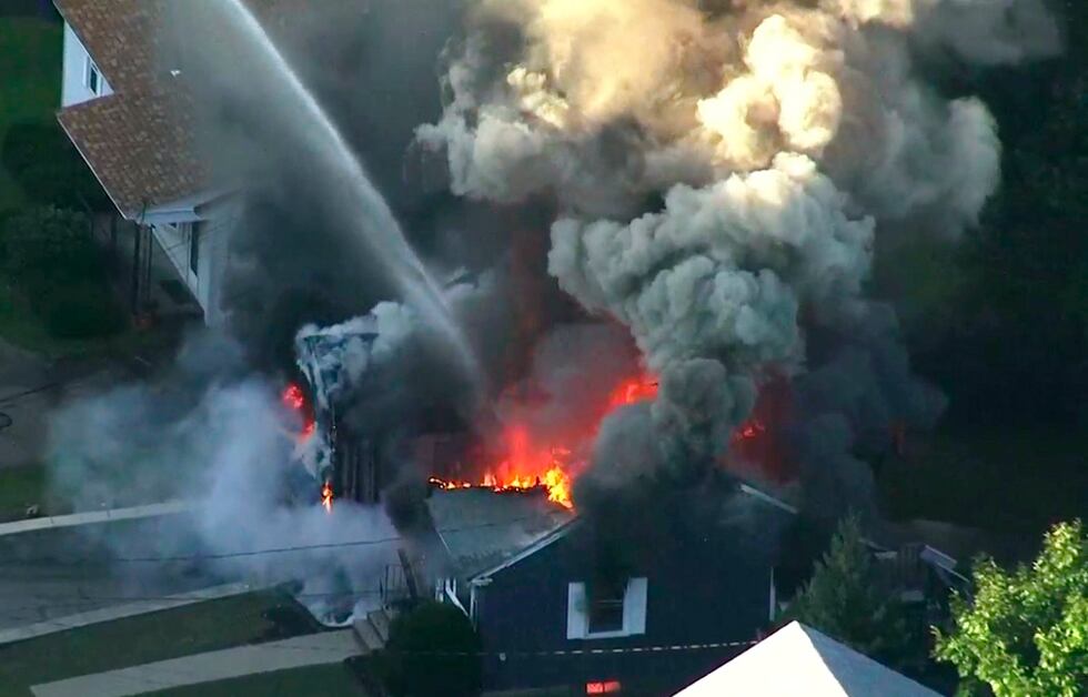 FILE - This image taken from video provided by WCVB in Boston shows flames consuming the roof...