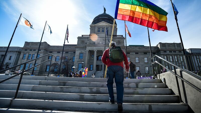 FILE - Demonstrators gather on the steps of the Montana state Capitol protesting anti-LGBTQ+...