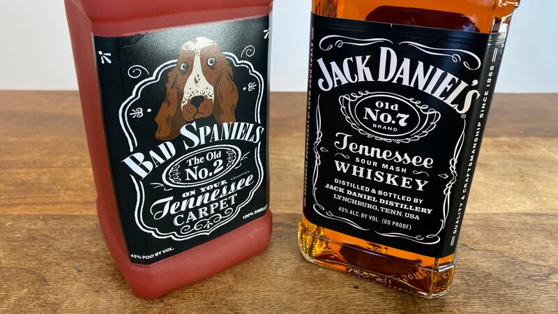 A bottle of Jack Daniel's Tennessee Whiskey is displayed next to a Bad Spaniels dog toy in...