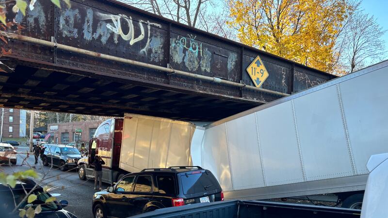 Tractor trailer stuck under bridge.