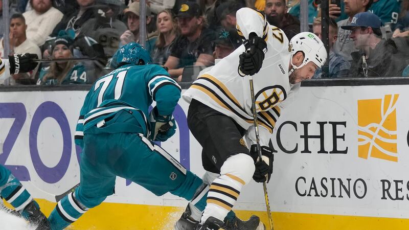 Boston Bruins left wing Milan Lucic (17) reaches for the puck in front of San Jose Sharks...