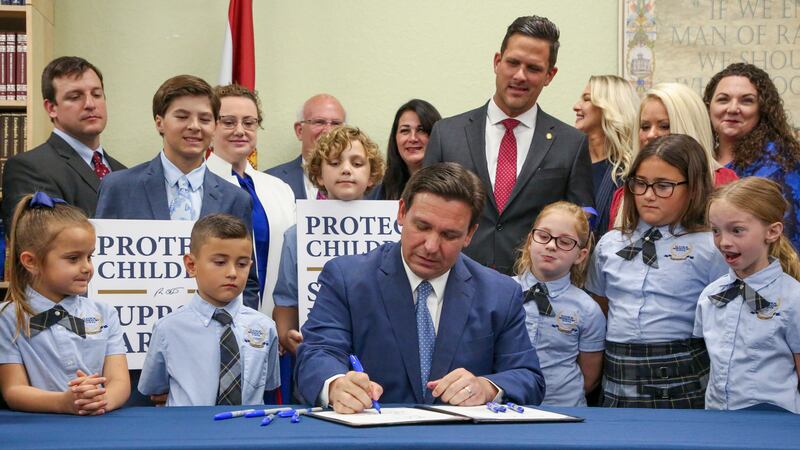 FILE - Florida Gov. Ron DeSantis signs the Parental Rights in Education bill at Classical...