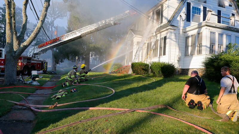 FILE - Firefighters battle a house fire on Herrick Road, Sept. 13, 2018, in North Andover,...